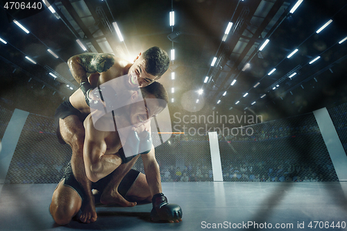 Image of Two professional boxers boxing on the ring