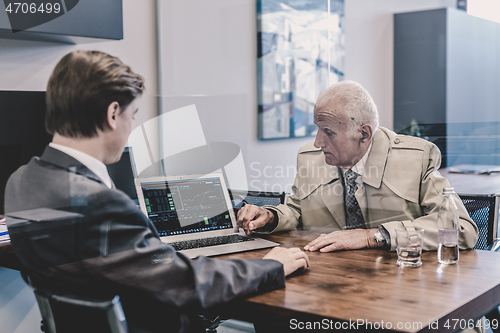 Image of Financial advisor consulting senior client with his investment strategy.