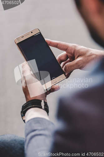 Image of Close up of businessman using mobile smart phone.