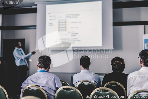 Image of Audience in lecture hall participating at business conference.