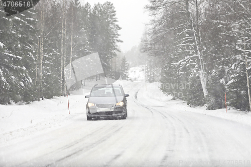 Image of Car Driving on Winter Road