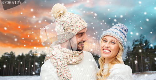 Image of smiling couple in winter clothes hugging