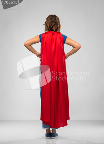 Image of back view of young woman in red superhero cape