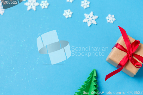 Image of gift box, christmas tree origami and snowflakes