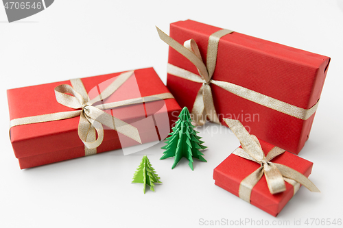 Image of gift boxes and christmas trees on white background