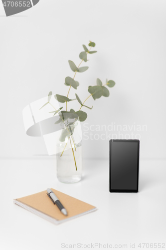 Image of smartphone with black screen on white office table