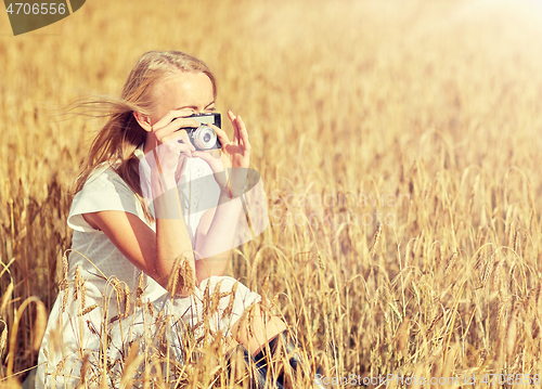 Image of woman taking picture with camera in cereal field
