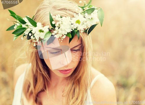 Image of happy woman in wreath of flowers