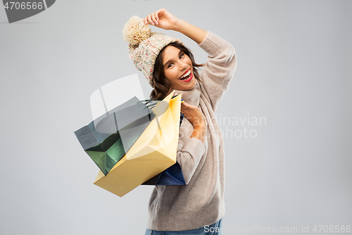 Image of young woman in winter hat with shopping bags