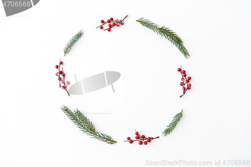 Image of christmas frame of fir branches with red berries