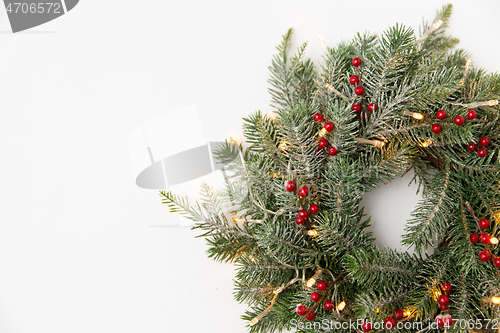 Image of christmas fir wreath with berries and lights