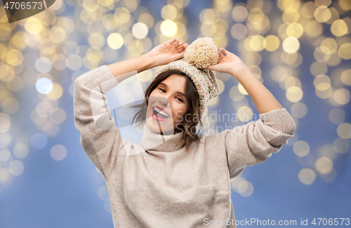 Image of woman in winter hat and sweater on christmas