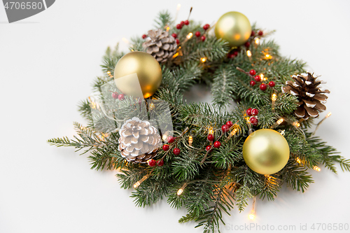 Image of christmas fir wreath with balls, cones and lights