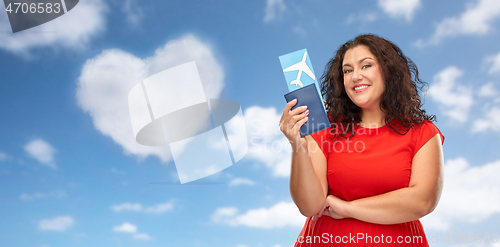 Image of happy woman with passport and air ticket