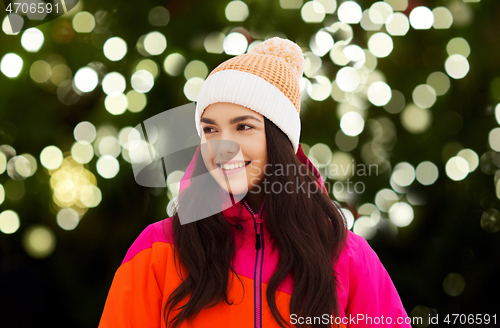 Image of happy young woman in winter clothes outdoors