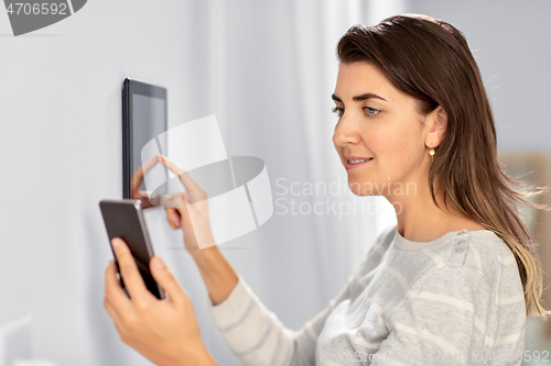 Image of woman using tablet computer and smartphone