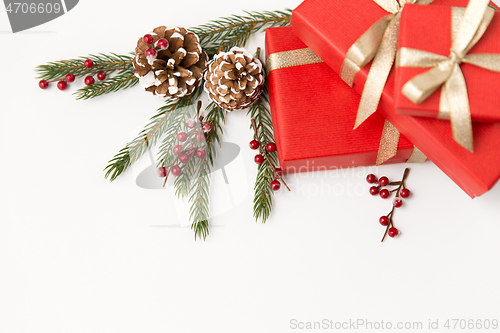 Image of christmas gifts and fir branches with pine cones