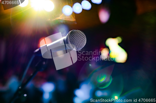 Image of Microphone on stage against a background of auditorium.