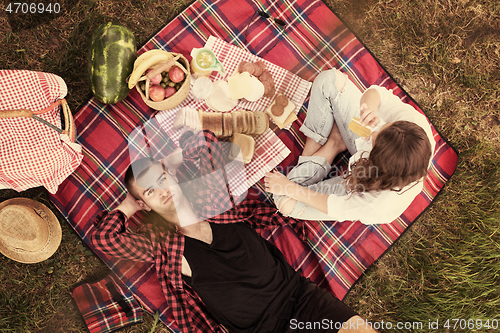 Image of top view of couple enjoying picnic time