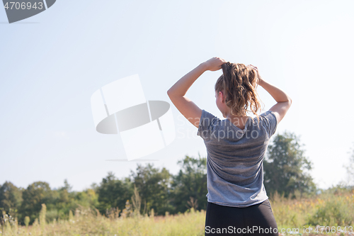 Image of woman jogging along a country road