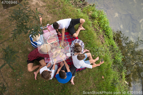 Image of top view of group friends enjoying picnic time