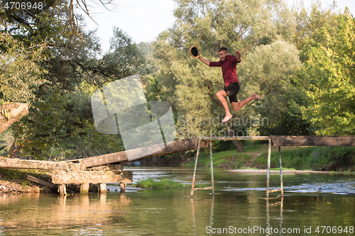 Image of man jumping into the river
