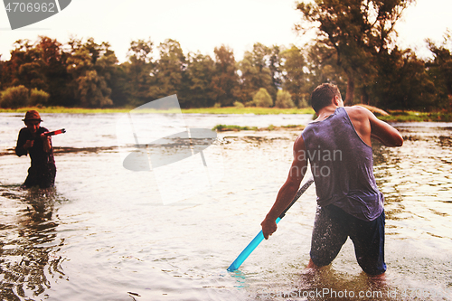 Image of young men having fun with water guns