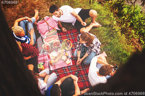 Image of top view of group friends enjoying picnic time