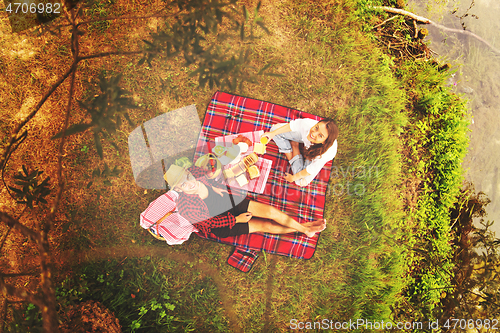 Image of top view of couple enjoying picnic time