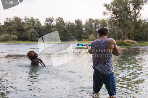 Image of young men having fun with water guns