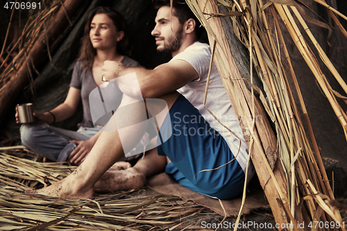 Image of couple spending time together in straw tent