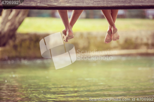 Image of people sitting at wooden bridge