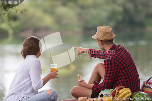 Image of Couple in love enjoying picnic time