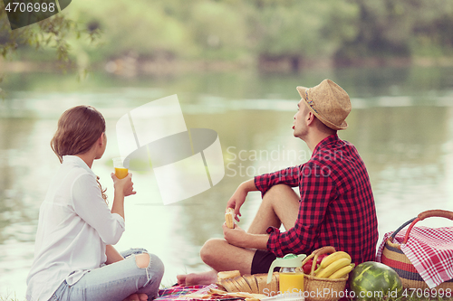 Image of Couple in love enjoying picnic time