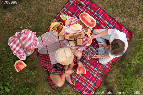 Image of top view of couple enjoying picnic time