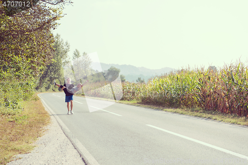 Image of happy couple jogging along a country road