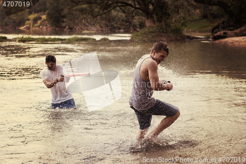 Image of young men having fun with water guns