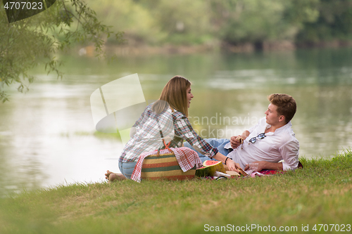 Image of Couple in love enjoying picnic time