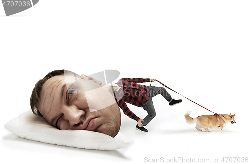 Image of Big head on small body lying on the pillow