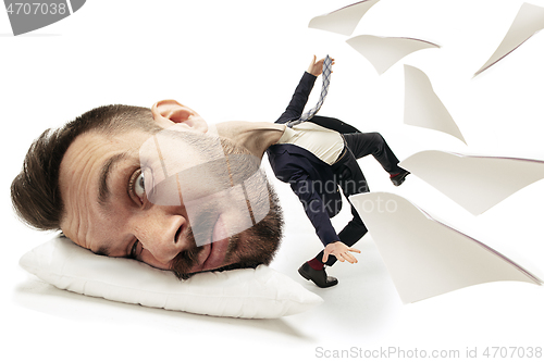 Image of Big head on small body lying on the pillow