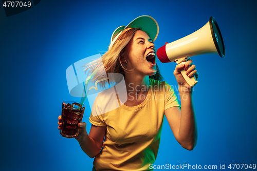 Image of Beautiful woman in neon light isolated on blue studio background