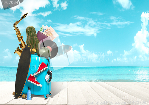 Image of Collage of luggage for travel in front of ocean view