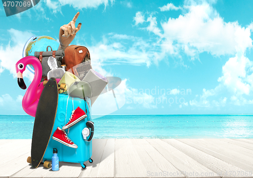 Image of Collage of luggage for travel in front of ocean view