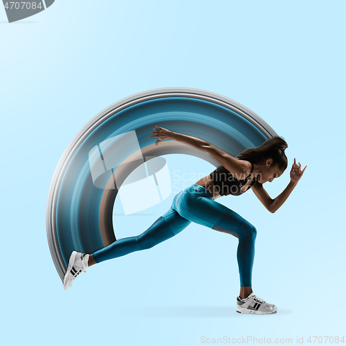 Image of Young african woman running or jogging isolated on blue studio background.