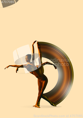 Image of Two young female ballet dancers under water drops