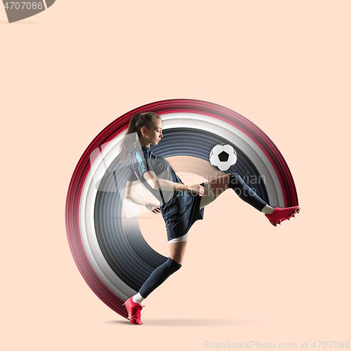 Image of Female soccer or football player kicking ball