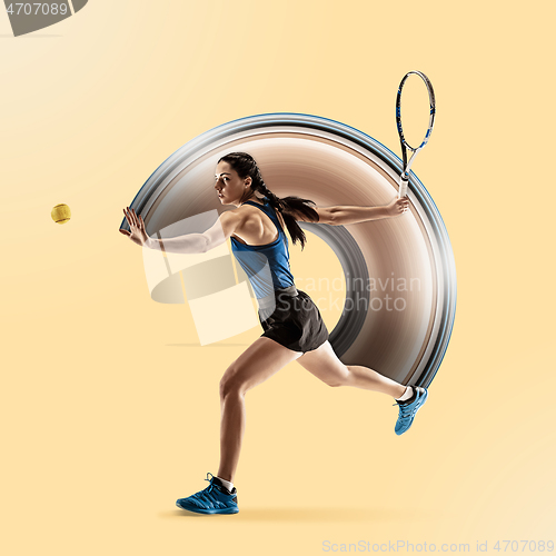 Image of Full length portrait of young woman playing tennis isolated on yellow background