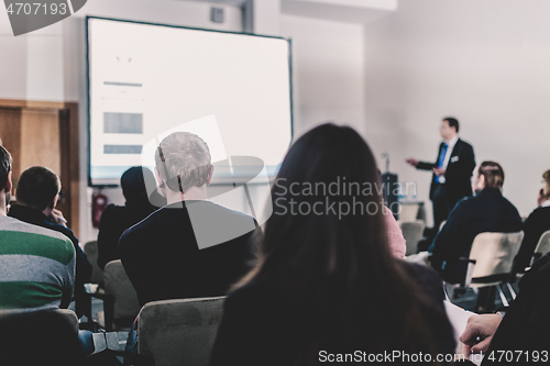 Image of Business speaker giving a talk at business conference event.