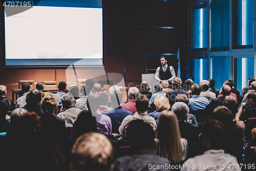 Image of Business speaker giving a talk at business conference meeting event.