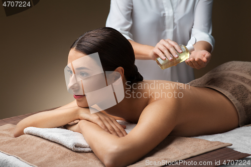 Image of beautiful woman having back massage at spa